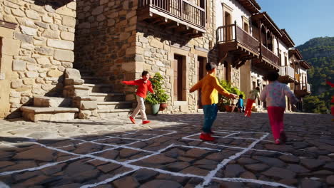 children playing hopscotch in a picturesque old european town