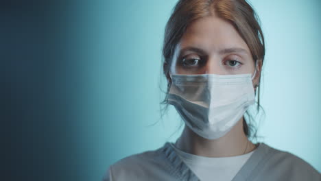 studio portrait of young female doctor in medical mask