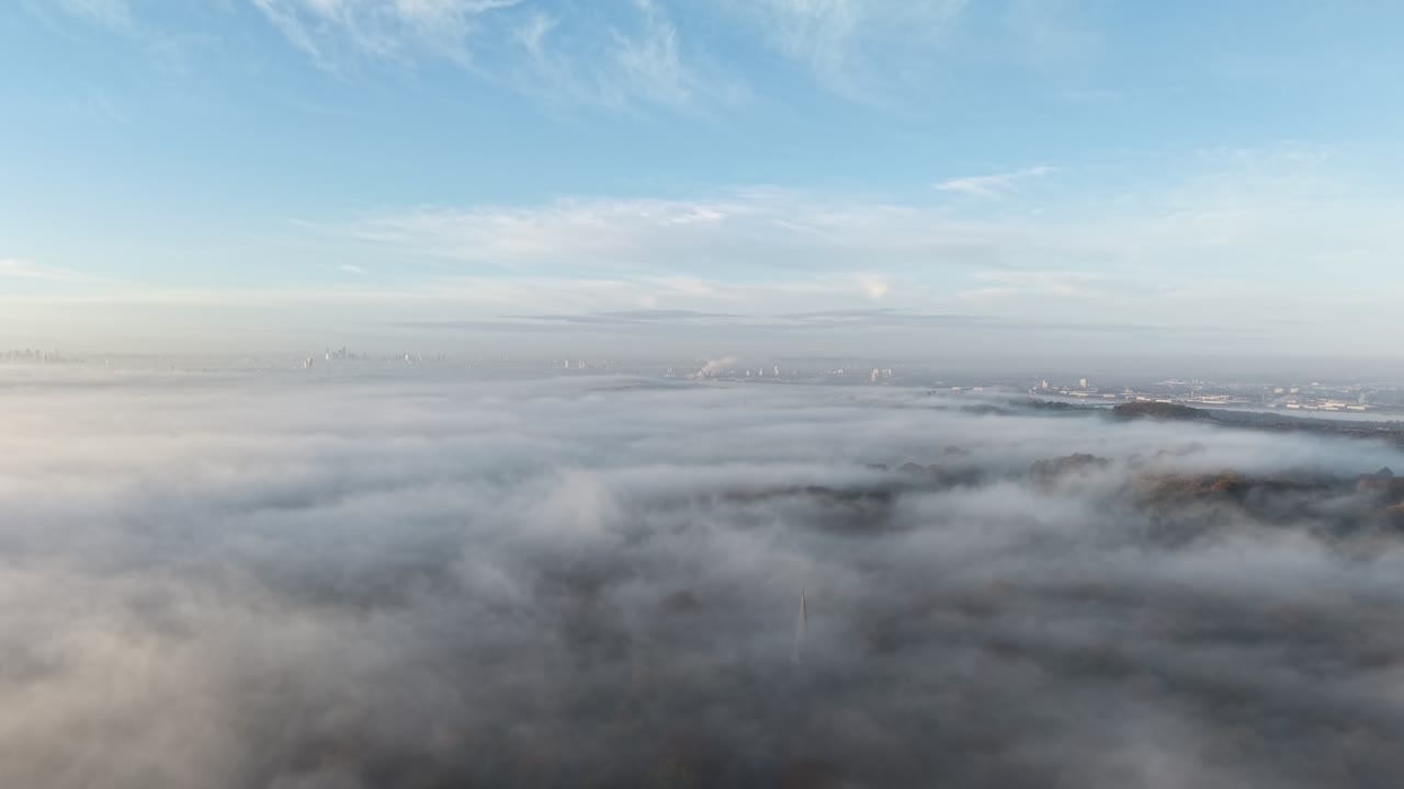 Aerial Epping forest UK early morning mist London skyline in distance