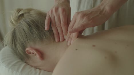 close-up of a woman receiving a relaxing neck and shoulder massage