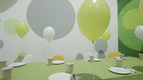 vibrant party room setup with balloons and table settings