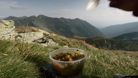 a tourist camping in high altitude mountains and eating healthy paleo keto vegan lunch in west tatras mountains, slovakia