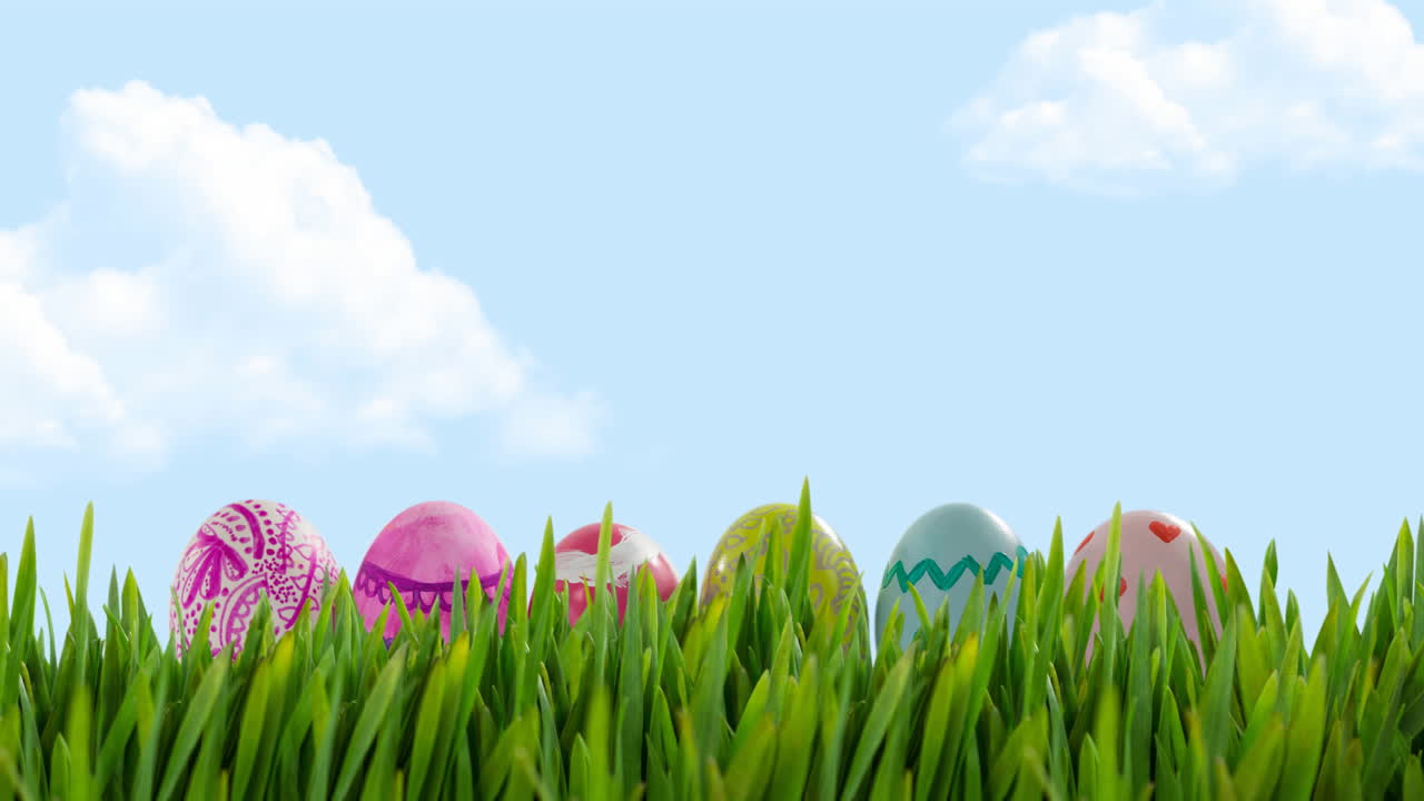Animation of multi coloured easter eggs in grass over blue sky