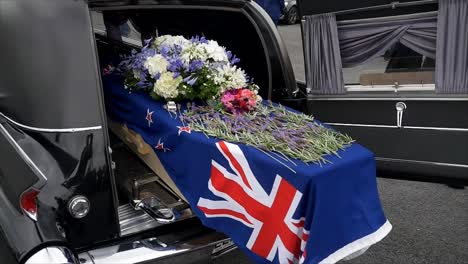 closeup shot of a funeral casket in a hearse or chapel or burial at cemetery