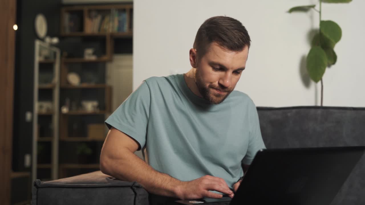 Concentrated man carefully reviews information on a laptop