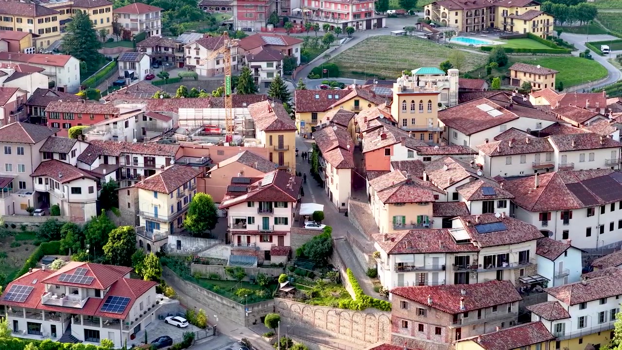 Ripresa aerea con drone cattura l'architettura storica e le dolci colline di Barolo, Italia.