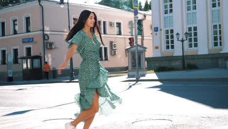 woman in a green dress on a city street