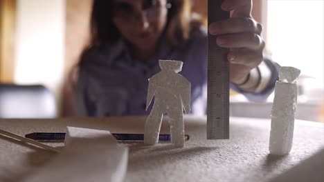 woman student working as architect building housing model mock-up