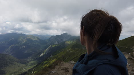 fantastic shot of woman enjoying the scenery of the tatra mountains including its wonderful lakes