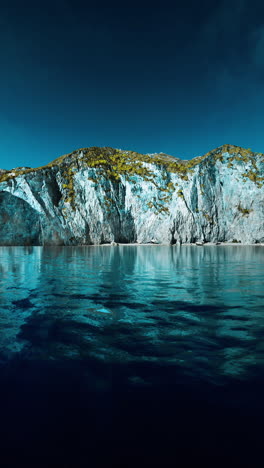 a stunning view of a mountain range rising out of the sea