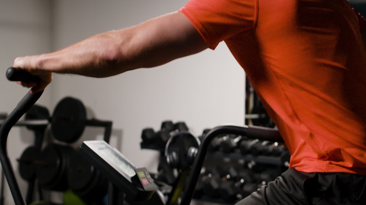 Man Exercising on Exercise Bike in Gym