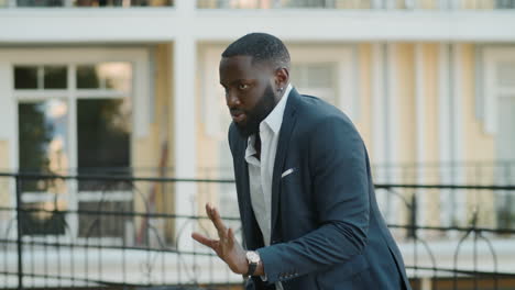 joyful businessman dancing outdoors