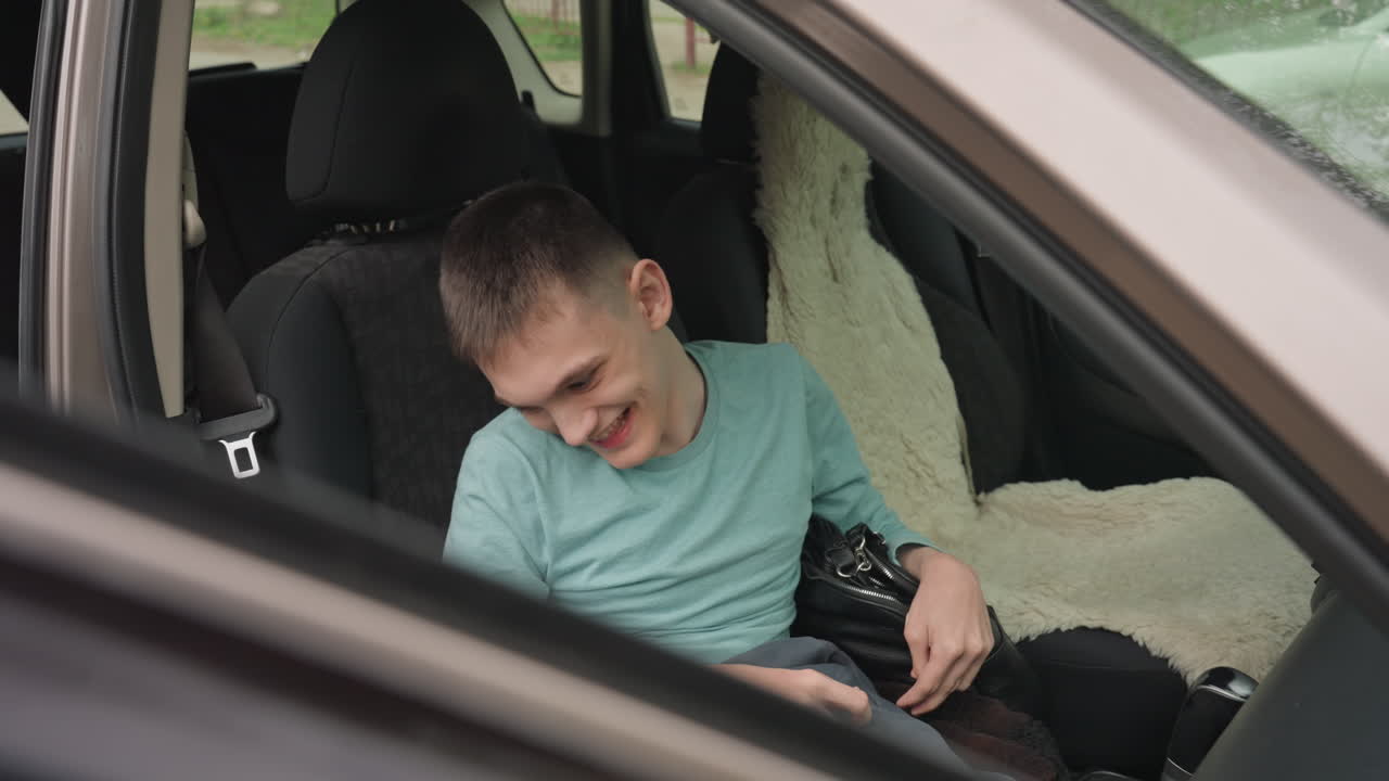 White Young Man Sitting In Parked Car, Relaxed Pose With Backpack, Small Smile And Casual Clothing, Moment Of Independence And Calm During Outing, Vehicle Interior And Accessible Seating