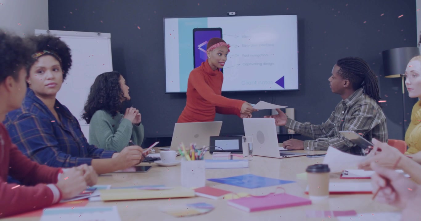 Woman presenter standing by screen starting meeting, handing handouts and guiding business review