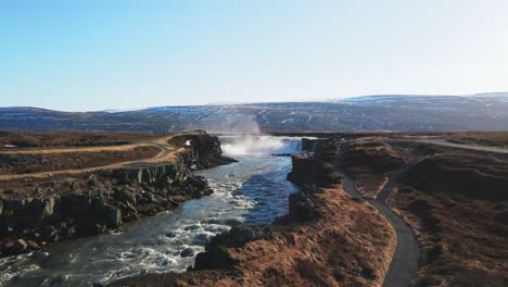 Icelandic-river-and-waterfall-with-mountains-on-the-background-drone-show-in-4K-4