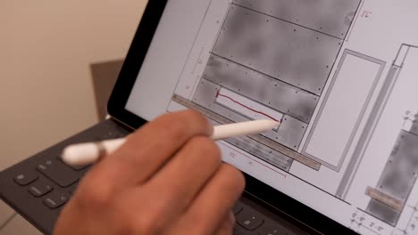 a person working on an architecture project on their tablet