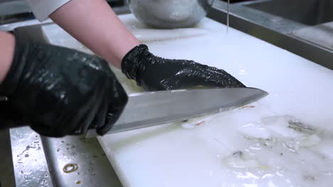A-chef-cleans-squid.-Raw-seafood