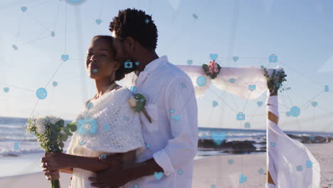 couple embracing on beach with social media icons and network animation over them