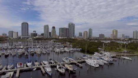 4k aerial drone video of sailboats at marina on tampa bay and skyline of high-rise condos in downtown st