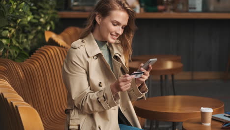 caucasian female student online shopping on smartphone outdoors.