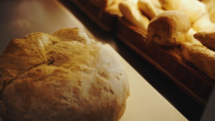 Slow motion tracking shot of a person showing a cutted big bread