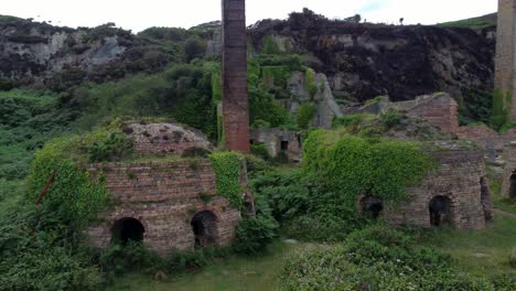 cinematic aerial footage orbiting the remains of the porth wen brickworks in anglesey, north wales, europe