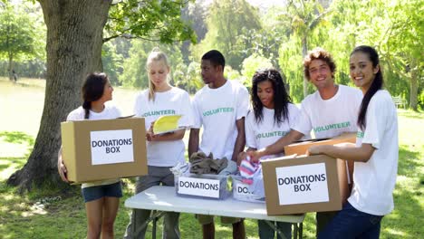 group of young volunteers sorting donation boxes