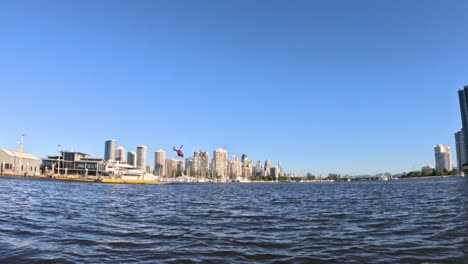 helicopter flying over gold coast cityscape and water