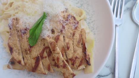 grilled chicken alfredo pasta with parmesan and basil