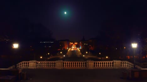 munich at night - looking over the railing to the straight long prinzregentenstraße with driving cars under the full moon