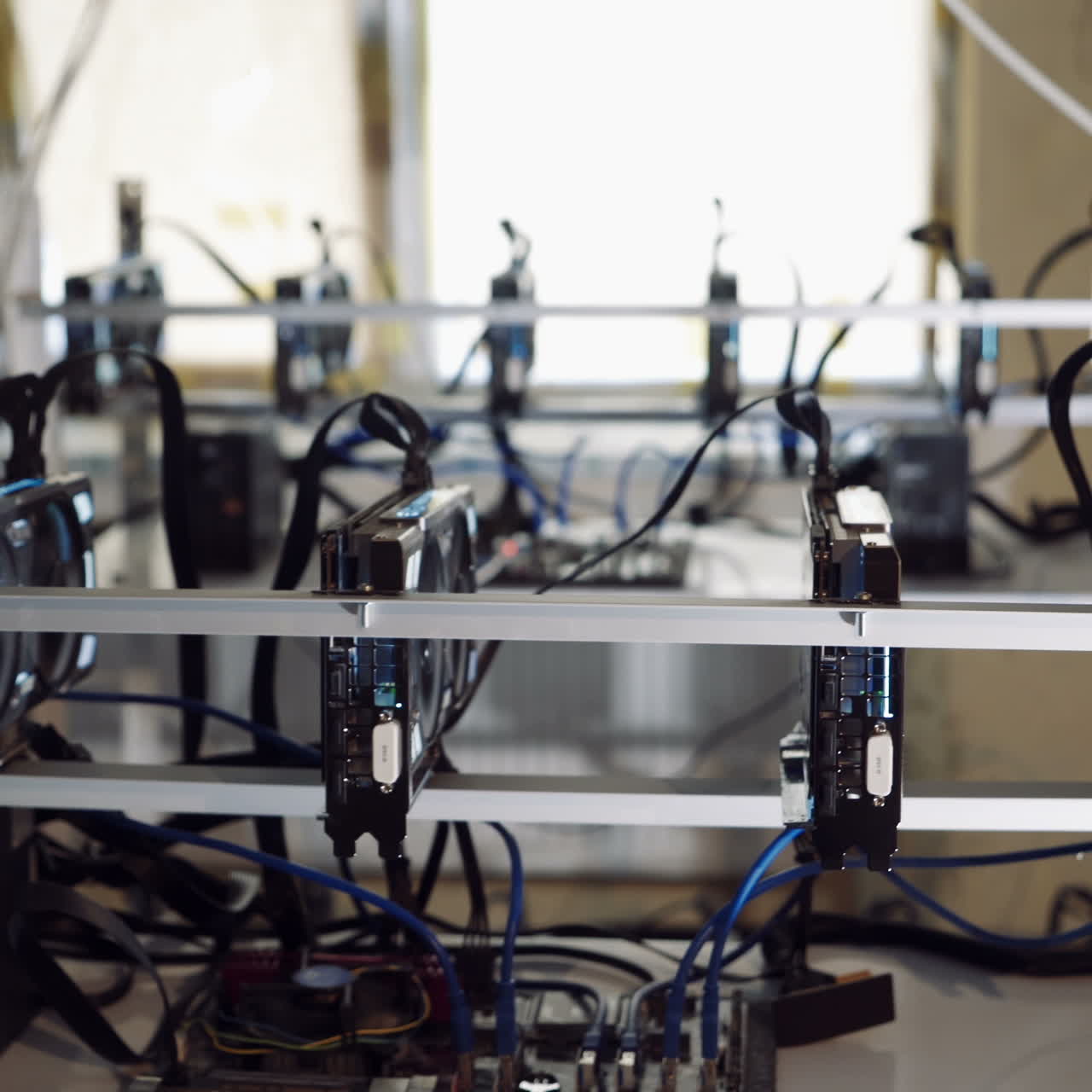 Bitcoin mining farm. Man checks the temperature of the graphics cards on the computer.