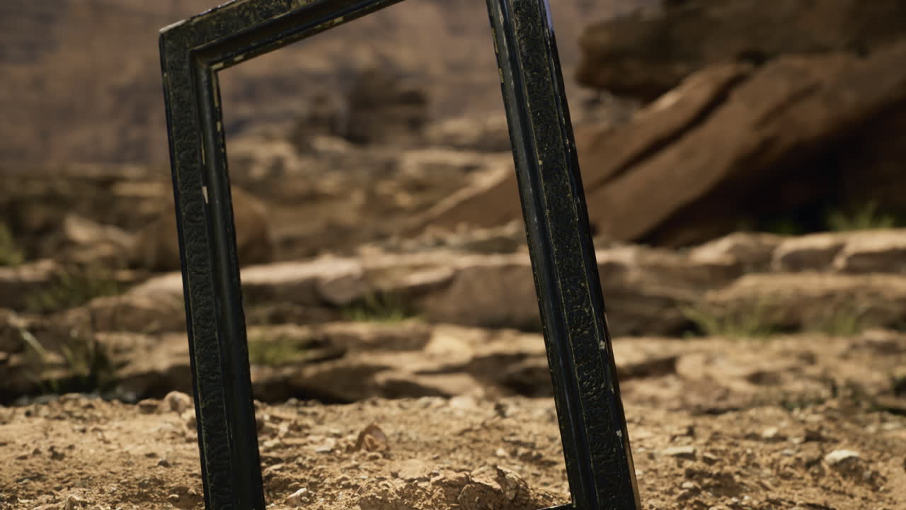 Artistic frame standing on rocky ground in a natural outdoor setting