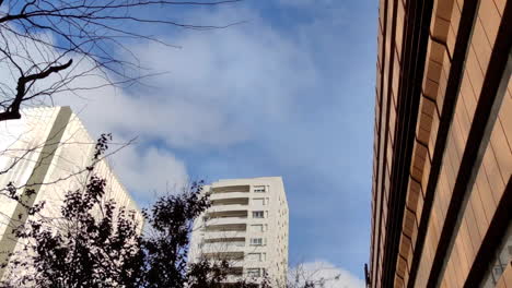 blue sky with clouds over the city buildings in lisbon, portugal