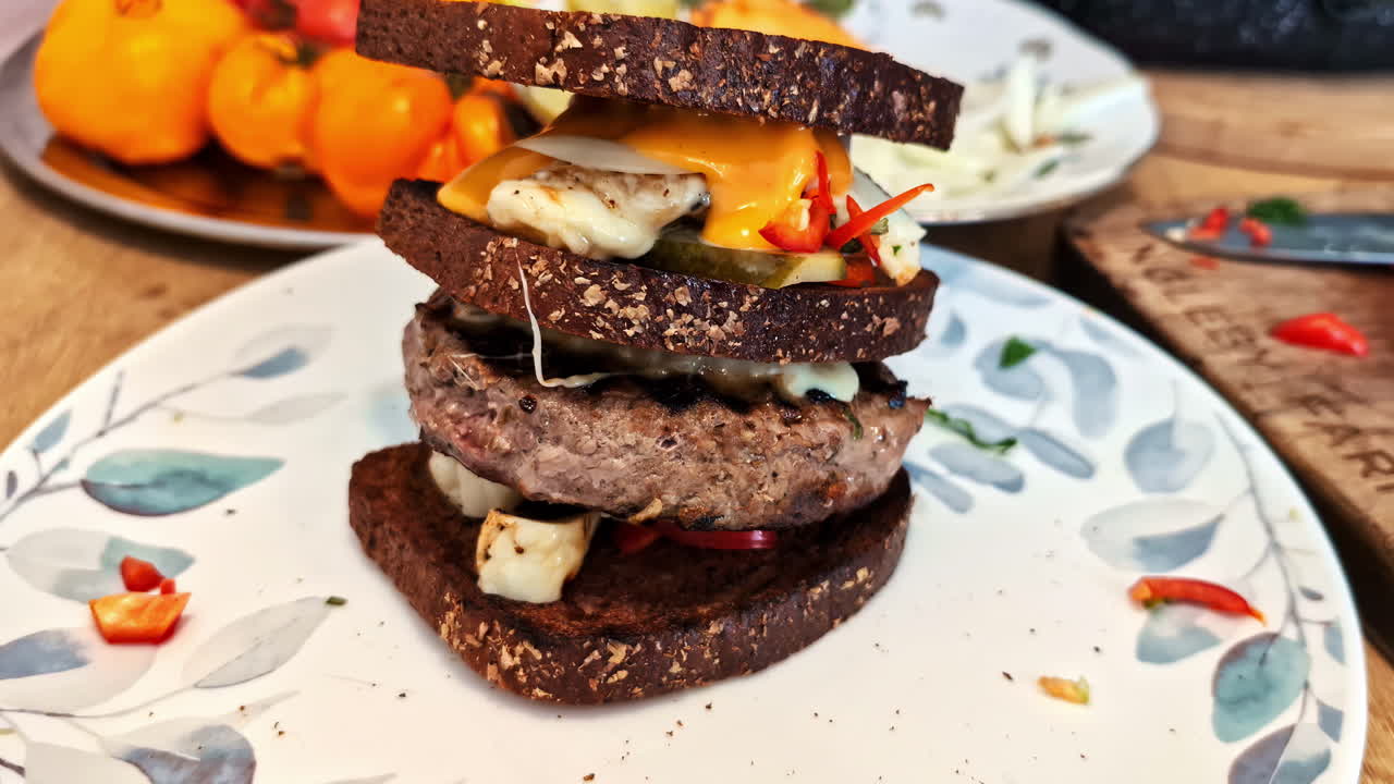 View of tasty burger with thick of meat and cheese served on plate at a restaurant in Jelgava, Latvia