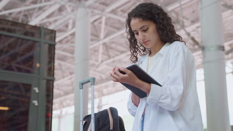 woman at airport checking flight details