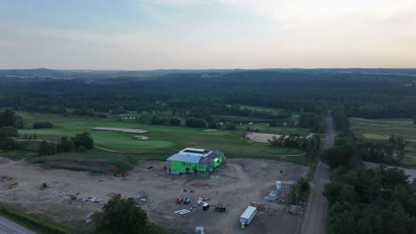 aerial: golf canada headquarters construction site at tpc toronto at osprey valley golf course in alton, caledon, ontario, canada, orbit drone shot