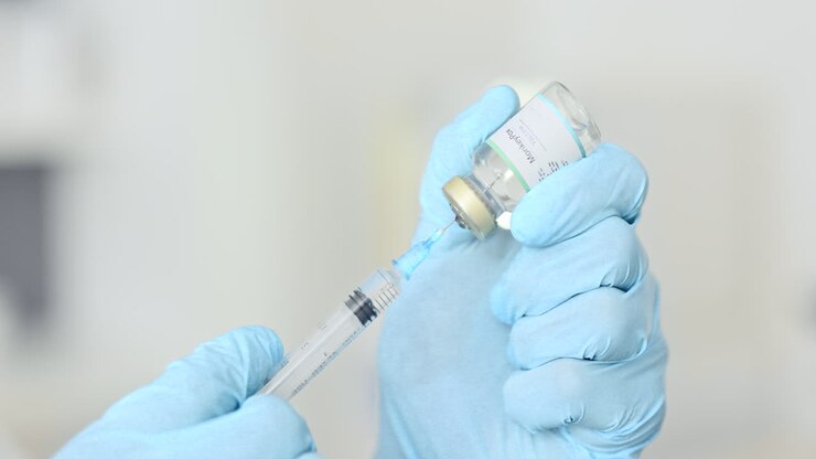 Doctor filling a syringe with a vaccine