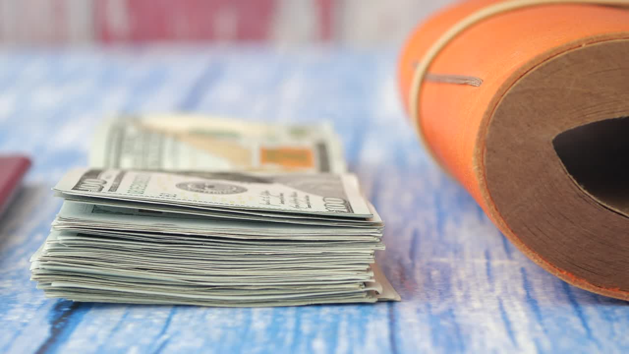 Money and travel documents on a wooden table
