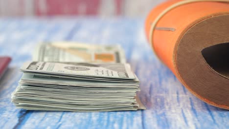 money and travel documents on a wooden table