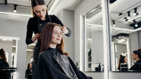 hairdresser styling client's hair at a modern salon