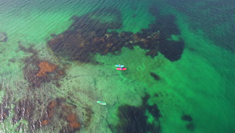 Close-up-sliding-shot-of-Tourist-paddling-in-a-Scenic-fjord-in-Lofoten-on-a-nice-summer-day