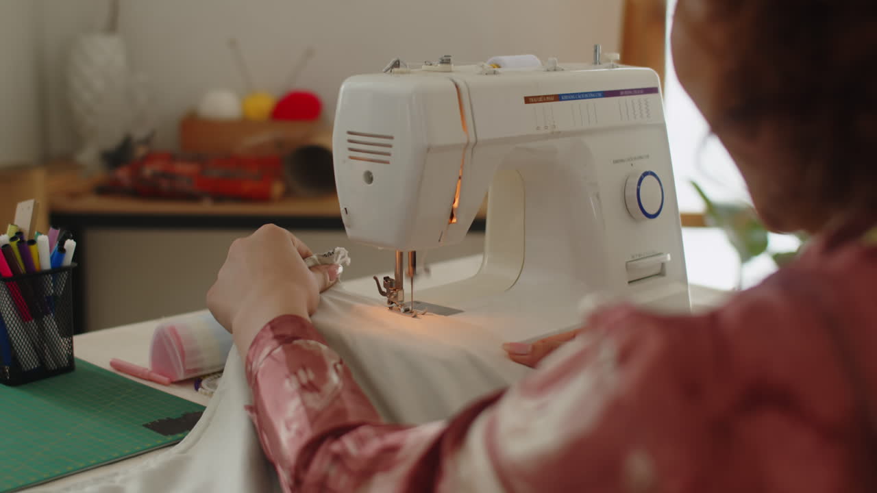 Unrecognizable Tailor Working on Sewing Machine