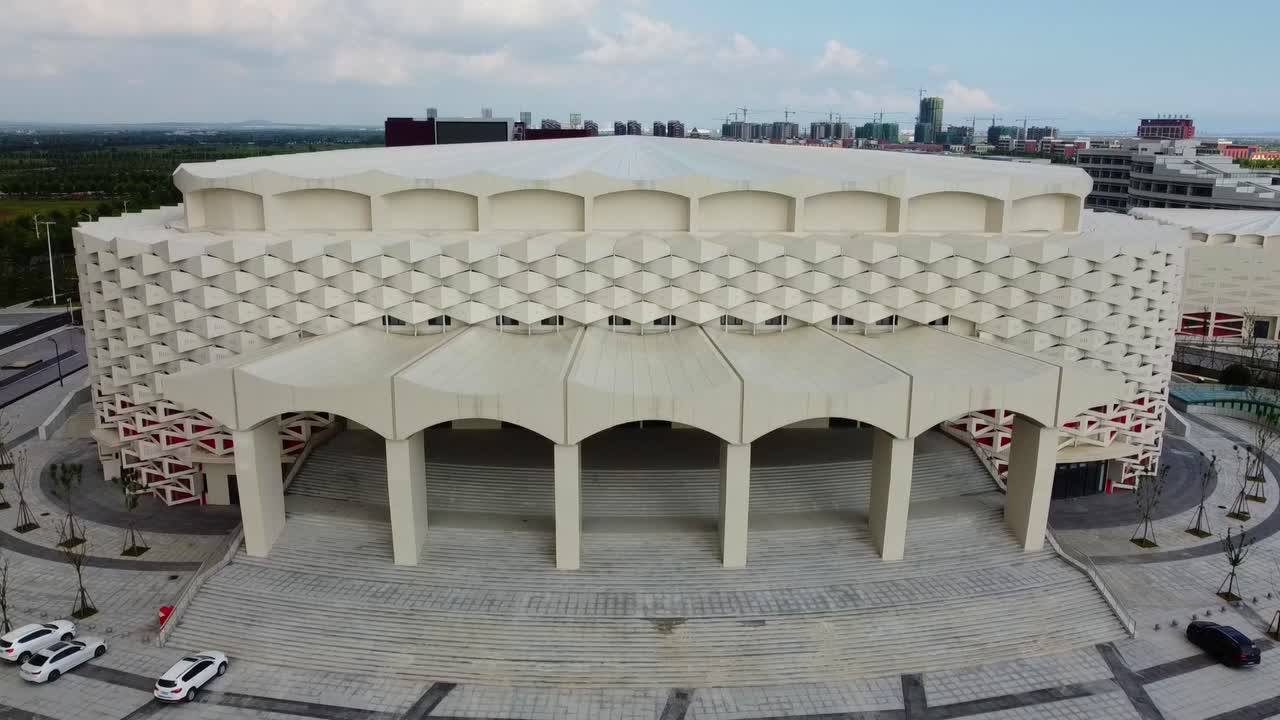 Weihai Olympic center indoor sports building complex aerial descending closeup view