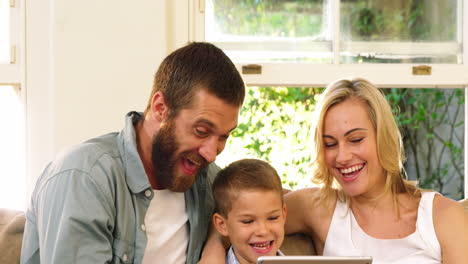 Parent-and-his-son-looking-at-tablet-computer