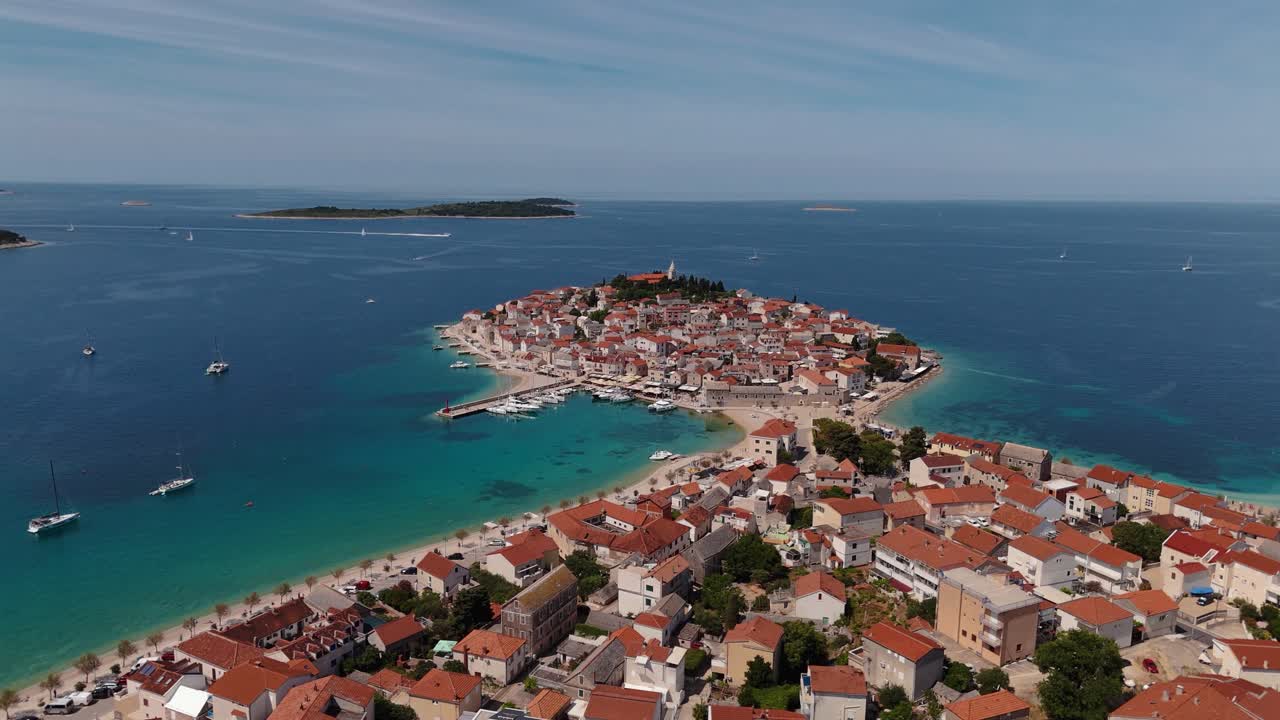 Primošten peninsula with marina and historic old town viewed from drone. Blue sky and sea. Croatia tourism