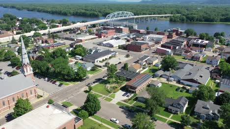 aerial view of a small town with a river and bridge