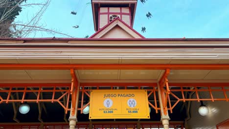 panoramic tilt up of a private, paid attraction inside the fantasilandia amusement park in santiago, chile on a sunny day.