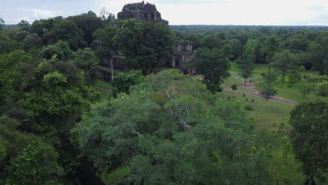 aerial rising over jungle wall reveals prasat thom temple in cambodia