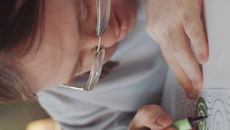 man coloring a picture