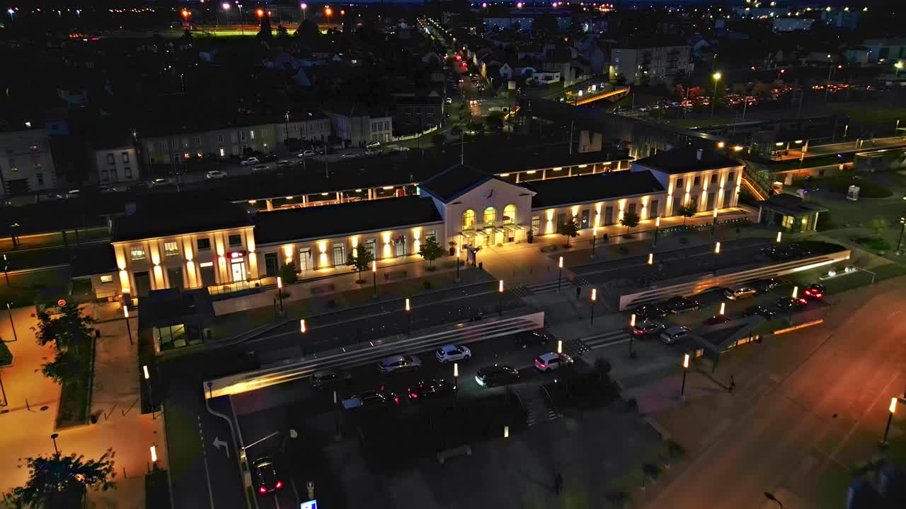 Laval station at night, Mayenne department, France. Aerial drone top-down forward